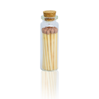 A small clear glass bottle with a cork stopper containing a set of wooden matches with brown tips, centered on a white background with a faint reflection below.