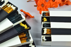 Matches in open and closed boxes with orange flowers in the background