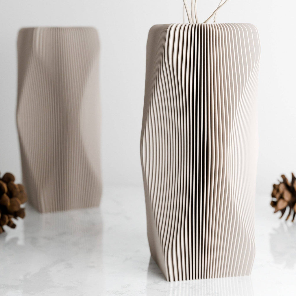 Cardboard vase with wavy design on a white background