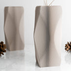 Cardboard vase with wavy design on a white background