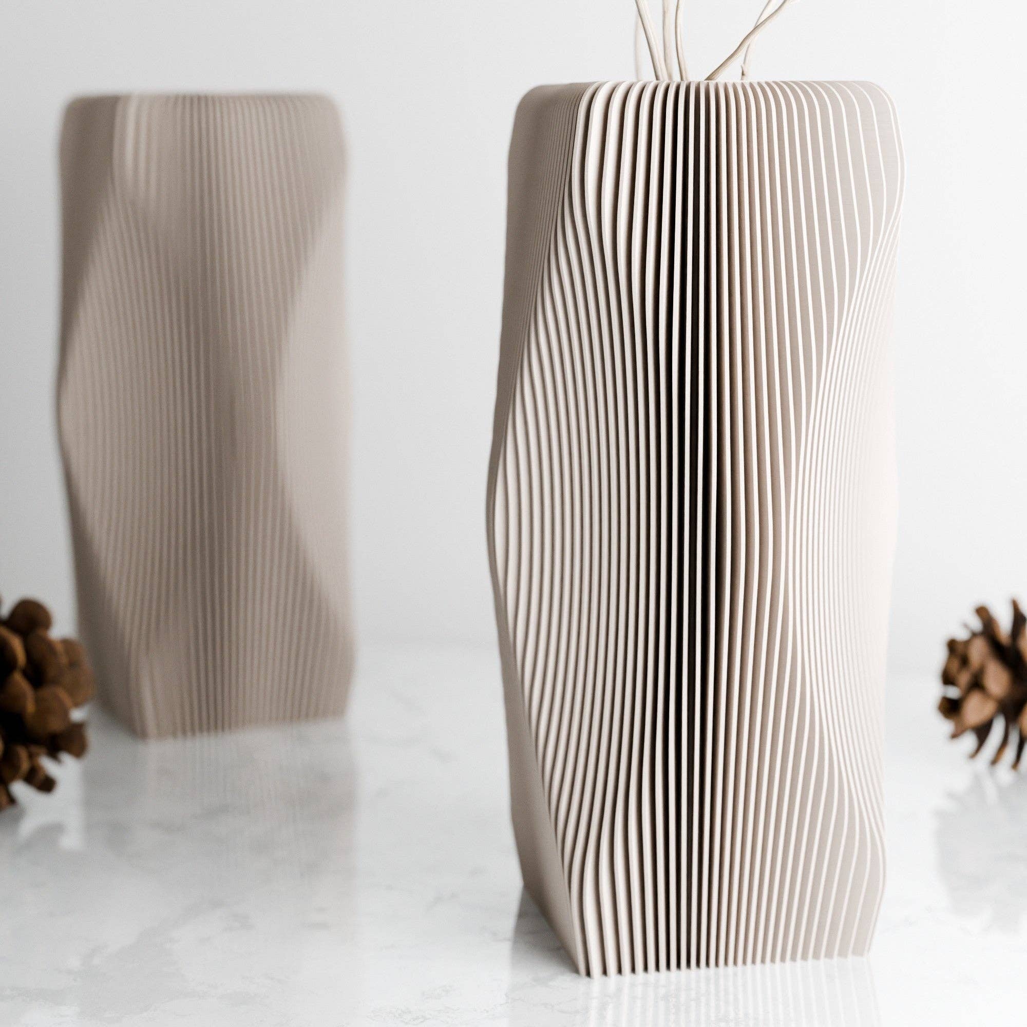 Cardboard vase with wavy design on a white background