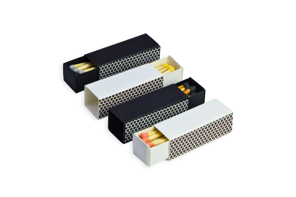 Set of four black and white matchboxes with matches inside on a white background