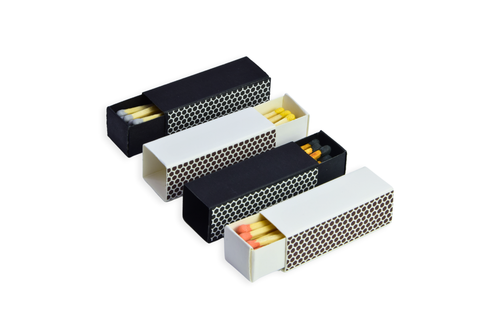 Set of four black and white matchboxes with matches inside on a white background