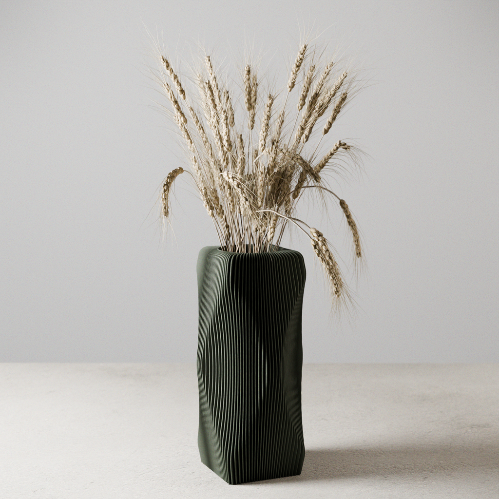 Black textured vase with dried plants on a light surface and gray background