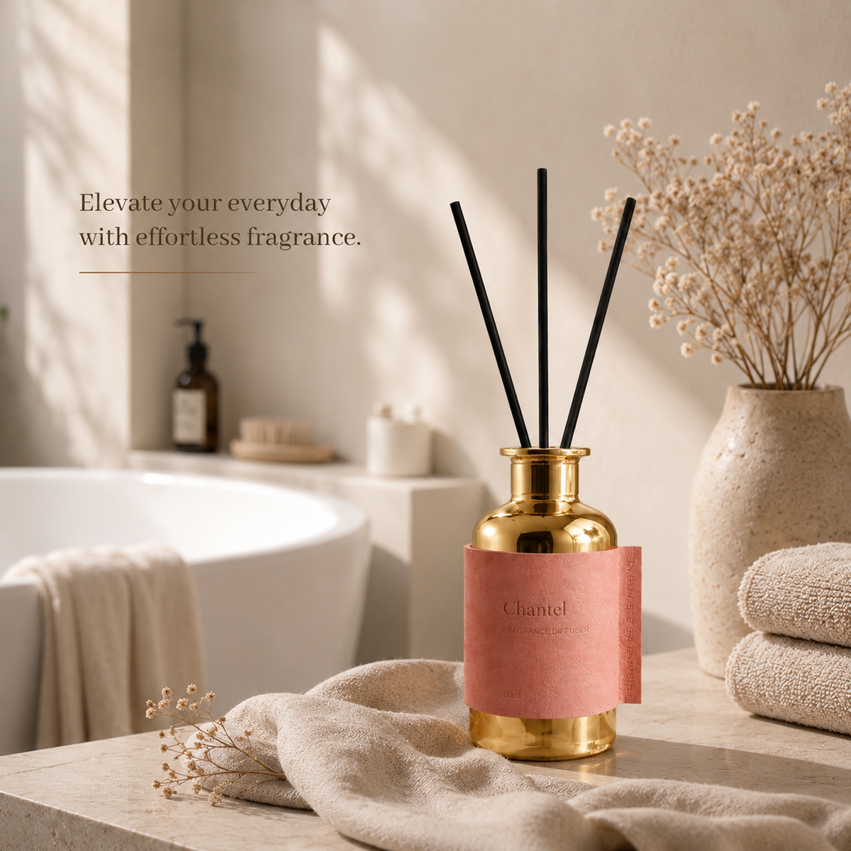 Gold diffuser with pink label on a bathroom counter, text 'Elevate your everyday with effortless fragrance'.