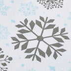 A close-up of a white fabric with a repeating pattern of gray snowflakes and light blue snowflake accents.