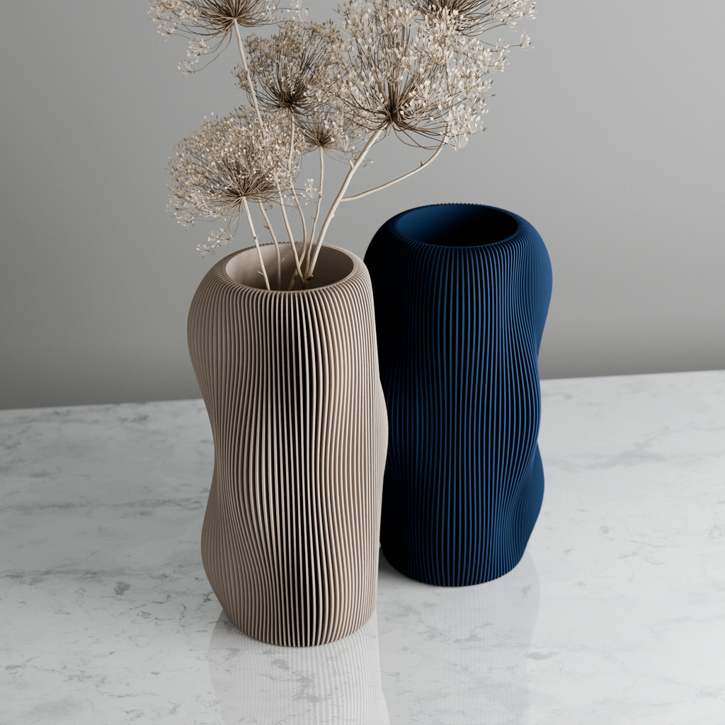 Two textured vases, one beige and one blue, on a marble surface with a gray background.