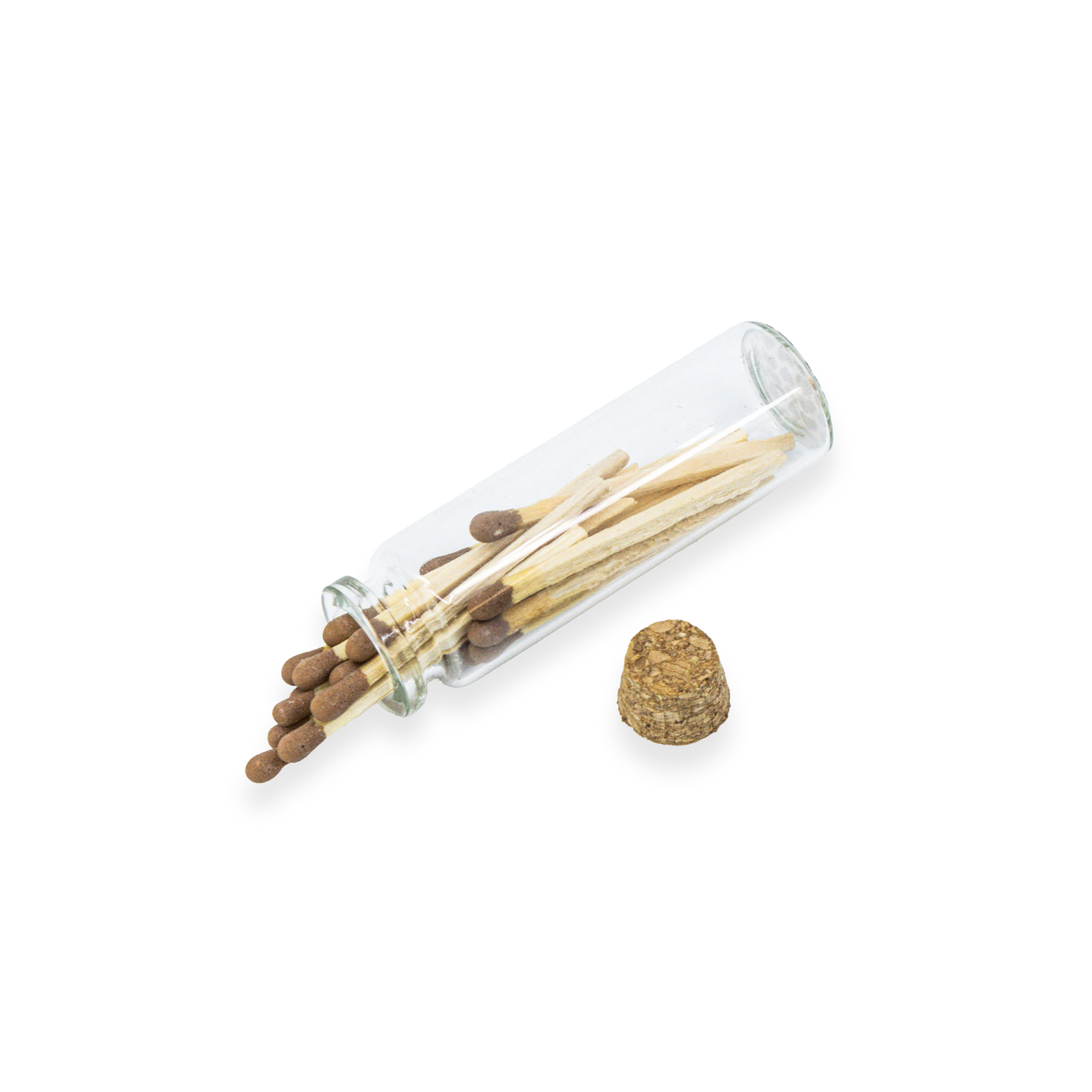 A clear glass match tube lying on its side with several wooden matches and brown match heads visible, plus a small cork stopper placed beside it on a white background.