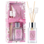 Diffuser set with pink packaging and white flowers on a white background