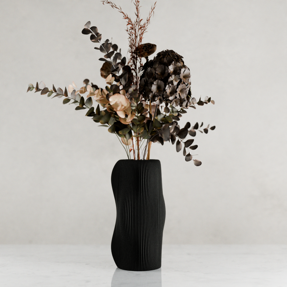 Black ribbed vase with dried flowers on a white background
