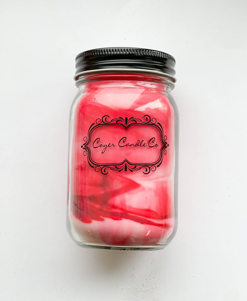 Coyer Candle Co candle in a glass jar with a black lid on a white background