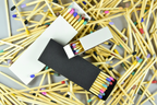 Matches with colorful heads scattered on a white background