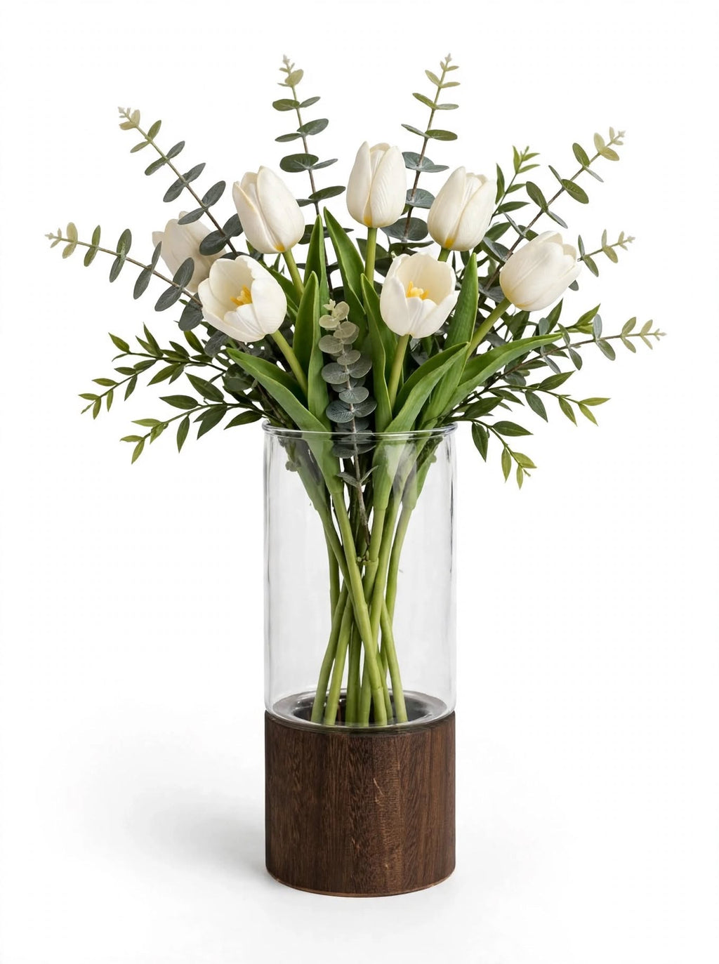 Clear smooth glass vase on wooden base styled with white tulips and eucalyptus