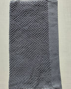 Close-up of dark gray cotton hand towel showing jacquard rhombus weave texture