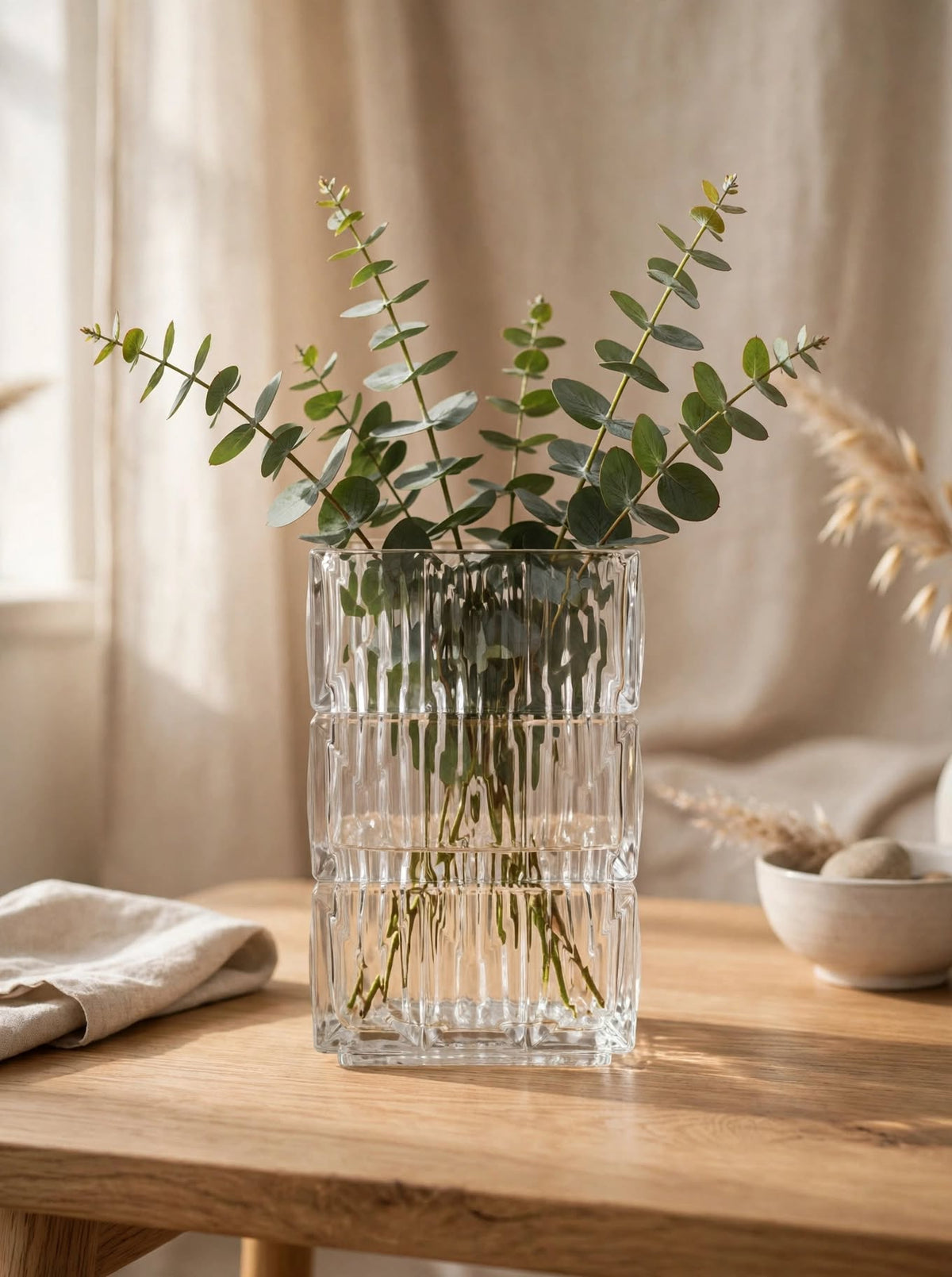 Close-up detail of clear square glass vase showing geometric diamond-cut ice-crackle texture
