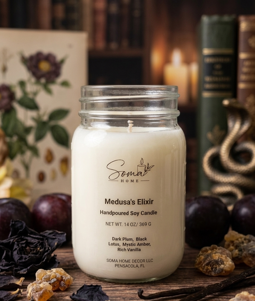A handpoured soy candle in a clear glass mason jar by Somal Home, labeled 'Medusa's Elixir,' set on a rustic wooden surface with dried herbs, dark plums, and books in the background.