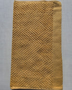 Close-up of dark yellow cotton hand towel showing jacquard rhombus weave texture