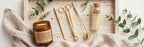 Candle Ritual gift set flat lay: amber jar candle, gold trimmer, snuffer, dipper and matches bottle on a travertine tray