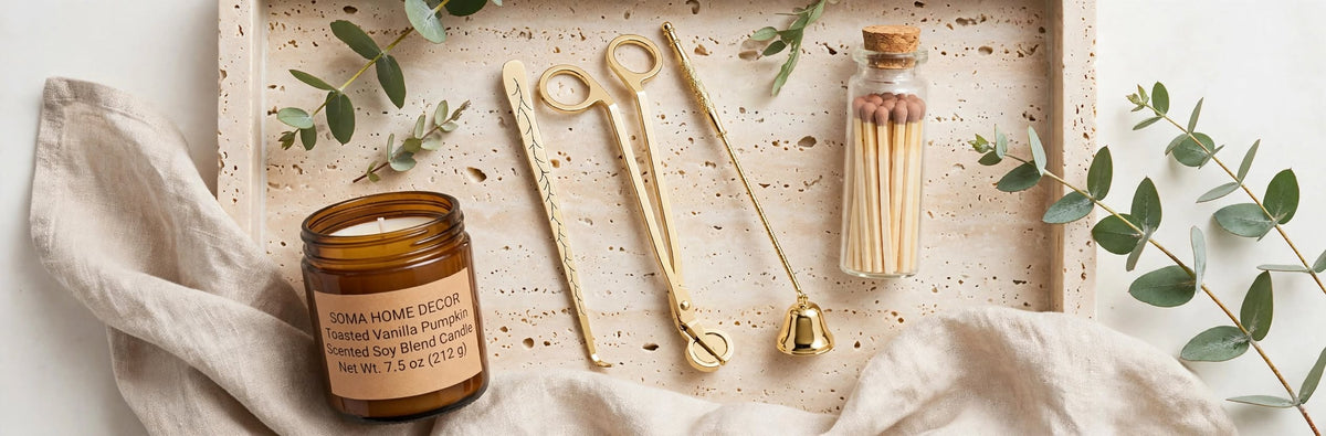 Candle Ritual gift set flat lay: amber jar candle, gold trimmer, snuffer, dipper and matches bottle on a travertine tray