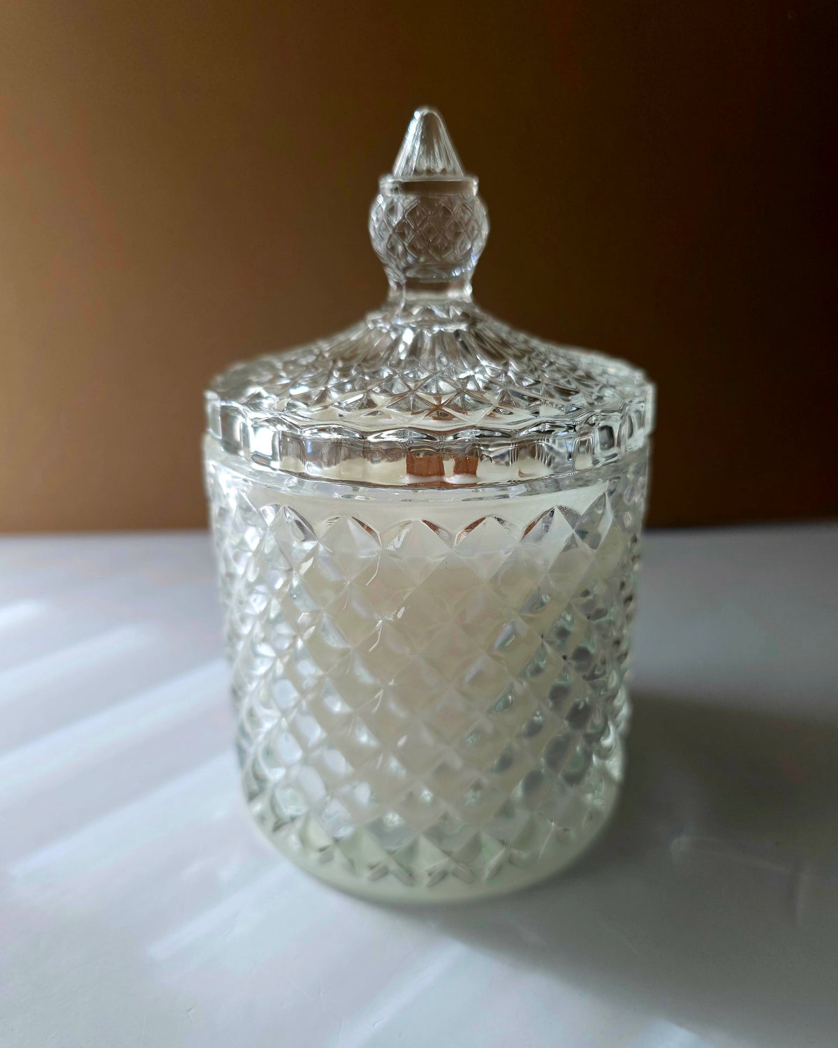 Artisanal fall candle in vintage-style cut crystal glass vessel featuring ornate pointed decorative lid