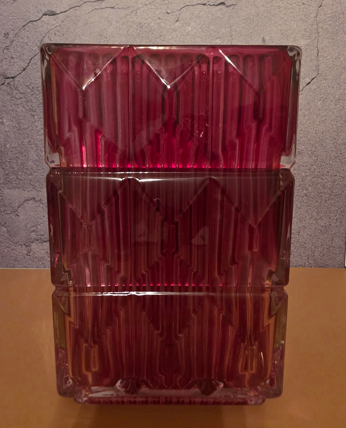 Close-up detail of magenta square glass vase showing geometric diamond-cut ice-crackle texture