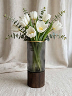 Smoky ribbed glass vase with gold rim styled with white tulips and eucalyptus
