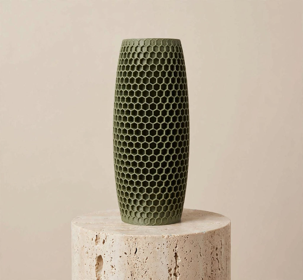 Muted green honeycomb vase, 6 inch, on a stone pedestal against a beige background
