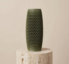 Muted green honeycomb vase, 6 inch, on a stone pedestal against a beige background