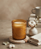 SOMA HOME Medium 8 oz Fresh Cotton Scented Candle in a textured amber glass jar, styled on a stone coaster with cotton bolls and a ceramic vase.